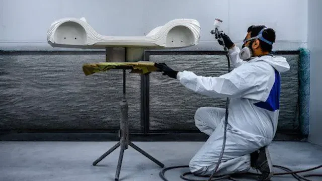 Close-up of a 3D printed part being hand-painted at the Orbit3D finishing workshop in Dubai
